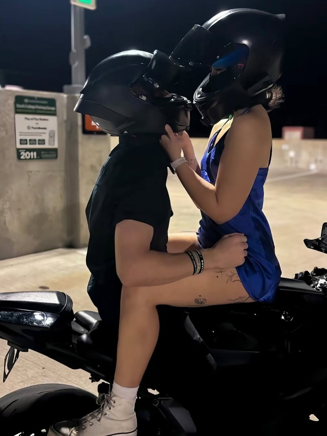 Photo by ❥ on August 11, 2025. May be an image of 1 person, people kissing, motorcycle, helmet and text.