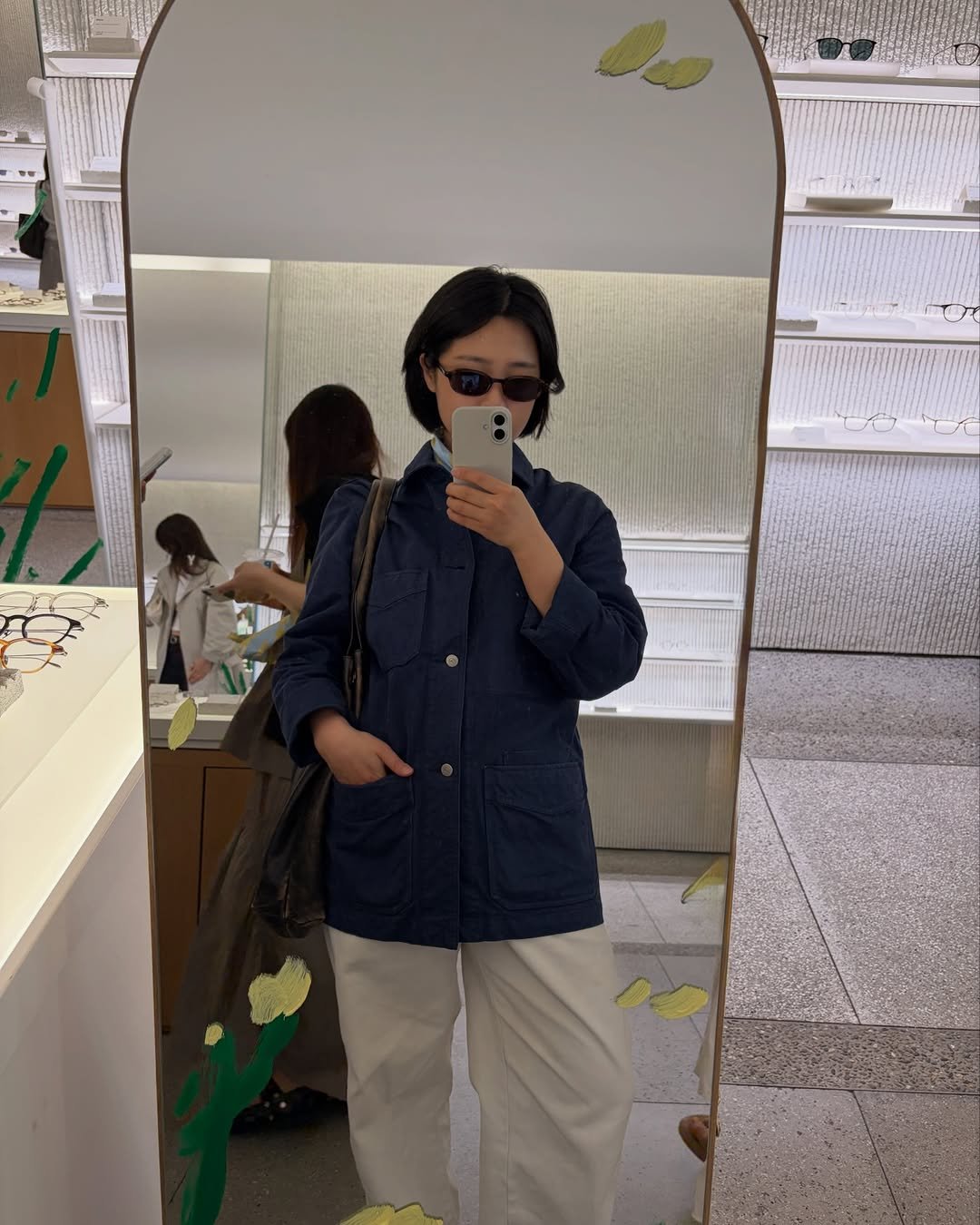 Photo shared by 무과수 MUGUASU on April 21, 2026 tagging @drakesdiary, and @yun.seoul. May be a selfie of duffle coat, overcoat, eyeglasses, sweatpants, mirror, raincoat, parka, cornflower and text.