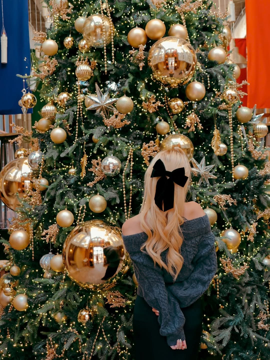 Photo shared by Kim Mumu on November 29, 2025 tagging @twohearts_bakery. May be an image of one or more people, blonde hair, christmas tree, tinsel and text.