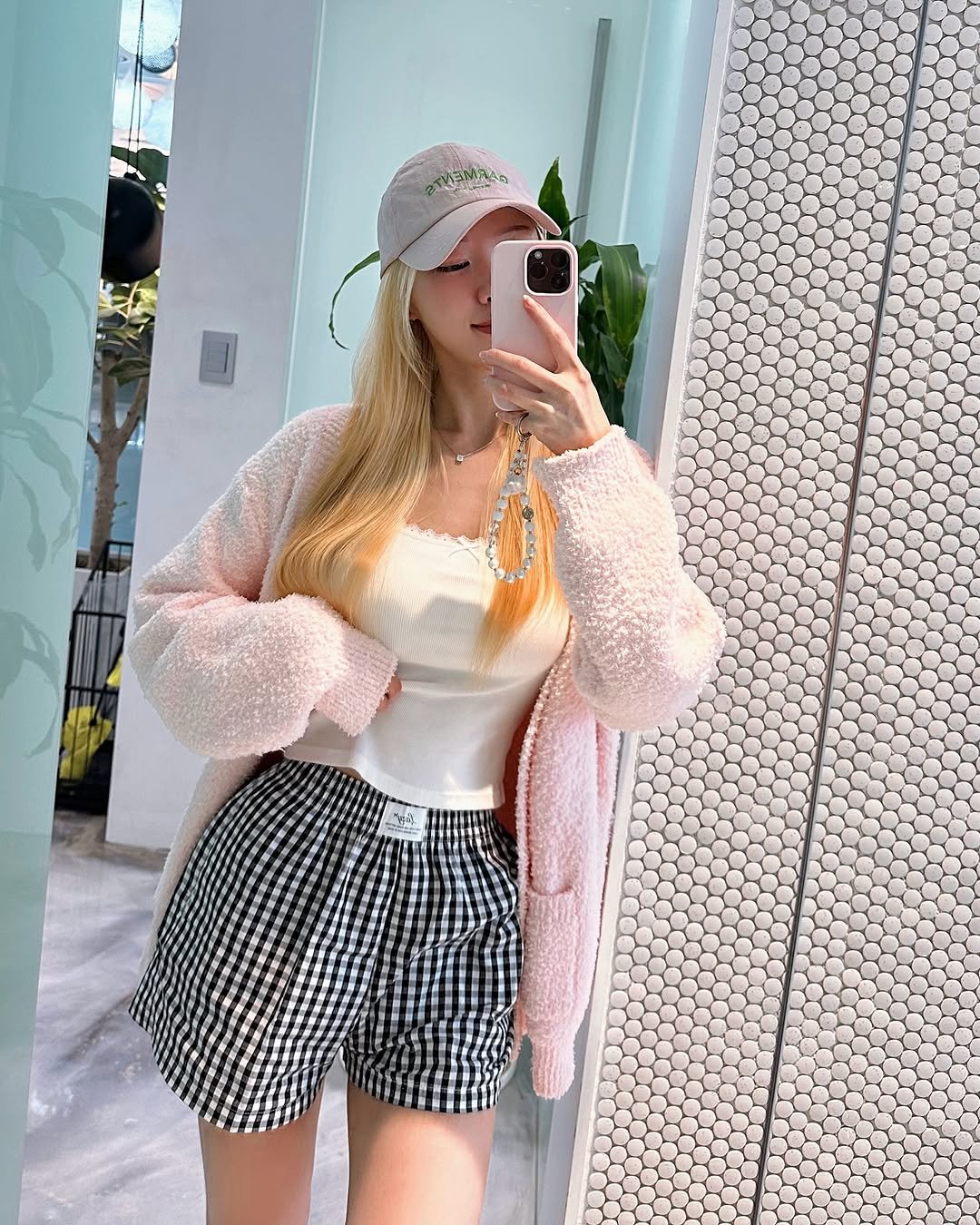 Photo by Kim Mumu on October 03, 2025. May be an image of 1 person, hat, shorts, outerwear, top, skirt, miniskirt, knit and text.