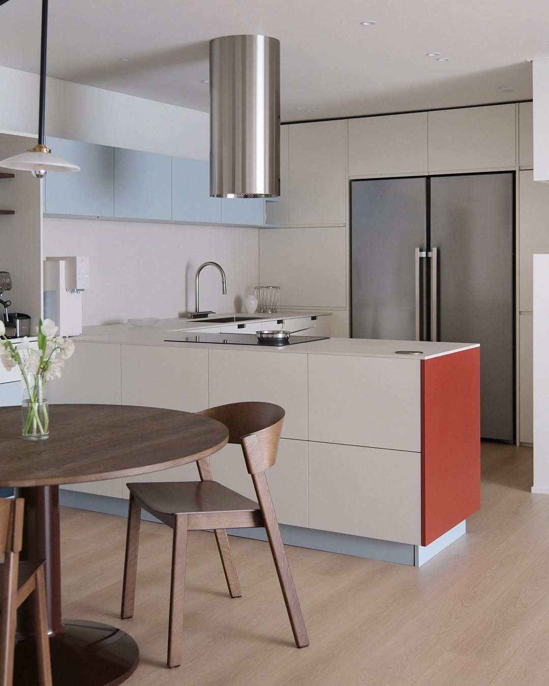 Photo shared by MMK_community on December 26, 2025 tagging @neospace1. May be an image of kitchen island, range hood, lighting, countertop, indoors, kitchen and text.