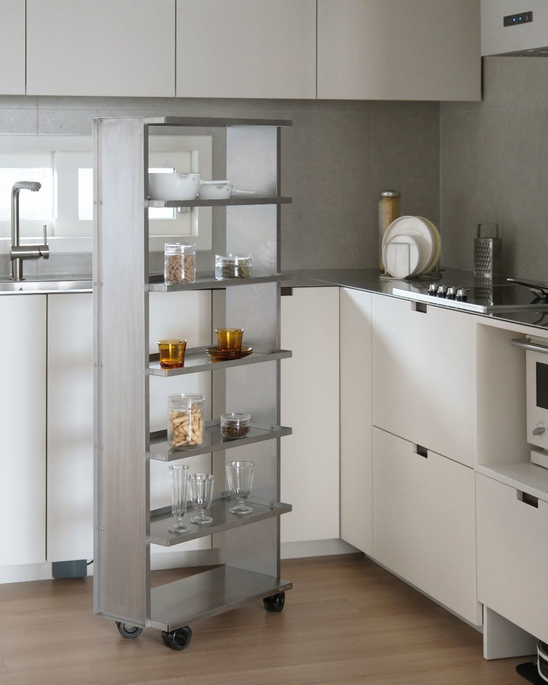 Photo by MMK_community on June 01, 2025. May be an image of sink, kitchen island, display case, kitchen appliance, rack, cabinet, indoors, kitchen and text.