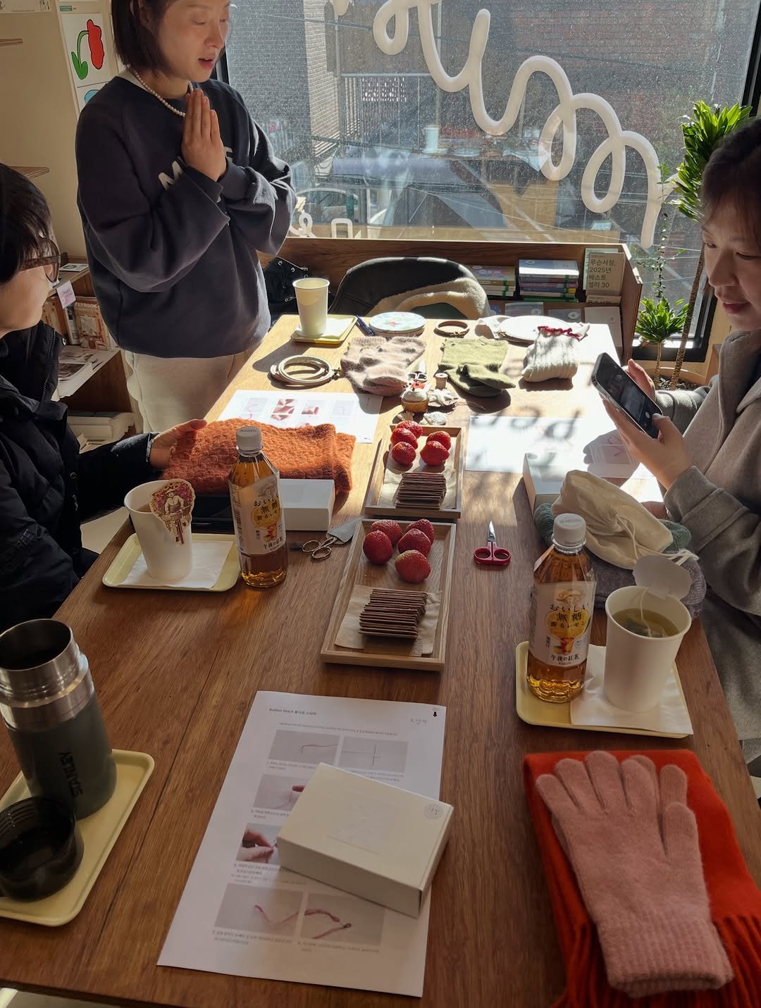Photo shared by 무슨서점 | 연남동서점 on December 24, 2025 tagging @the.pater, and @moyange.shop. May be an image of one or more people, people studying, cornflower and text.