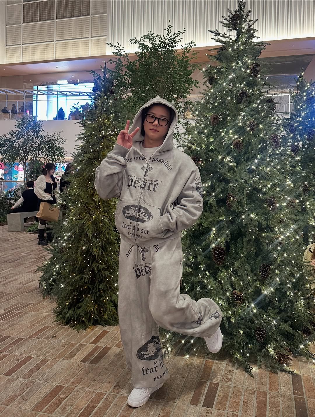 Photo by 난희 on December 25, 2025. May be an image of christmas tree, gingerbread cookie, sweatpants, sweater, tinsel, bath robe, sweatsuit and text.