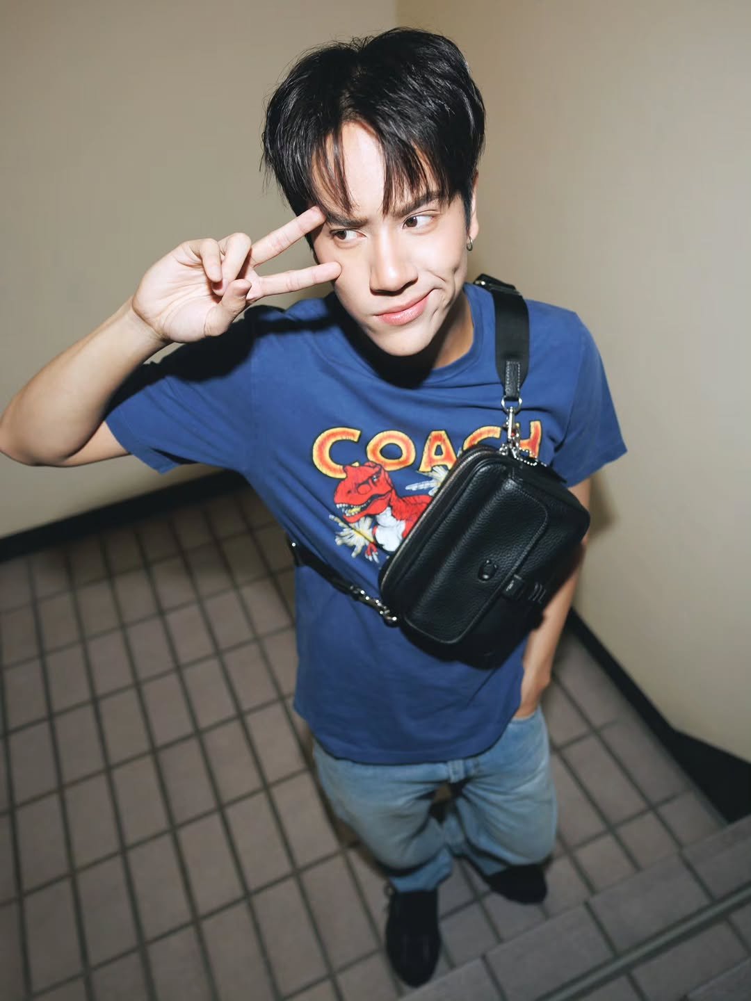 Photo shared by NANON on December 30, 2025 tagging @coach. May be an image of ‎one or more people, bangs, bolo tie and ‎text that says '‎CФA MN COACH و 말‎'‎‎.