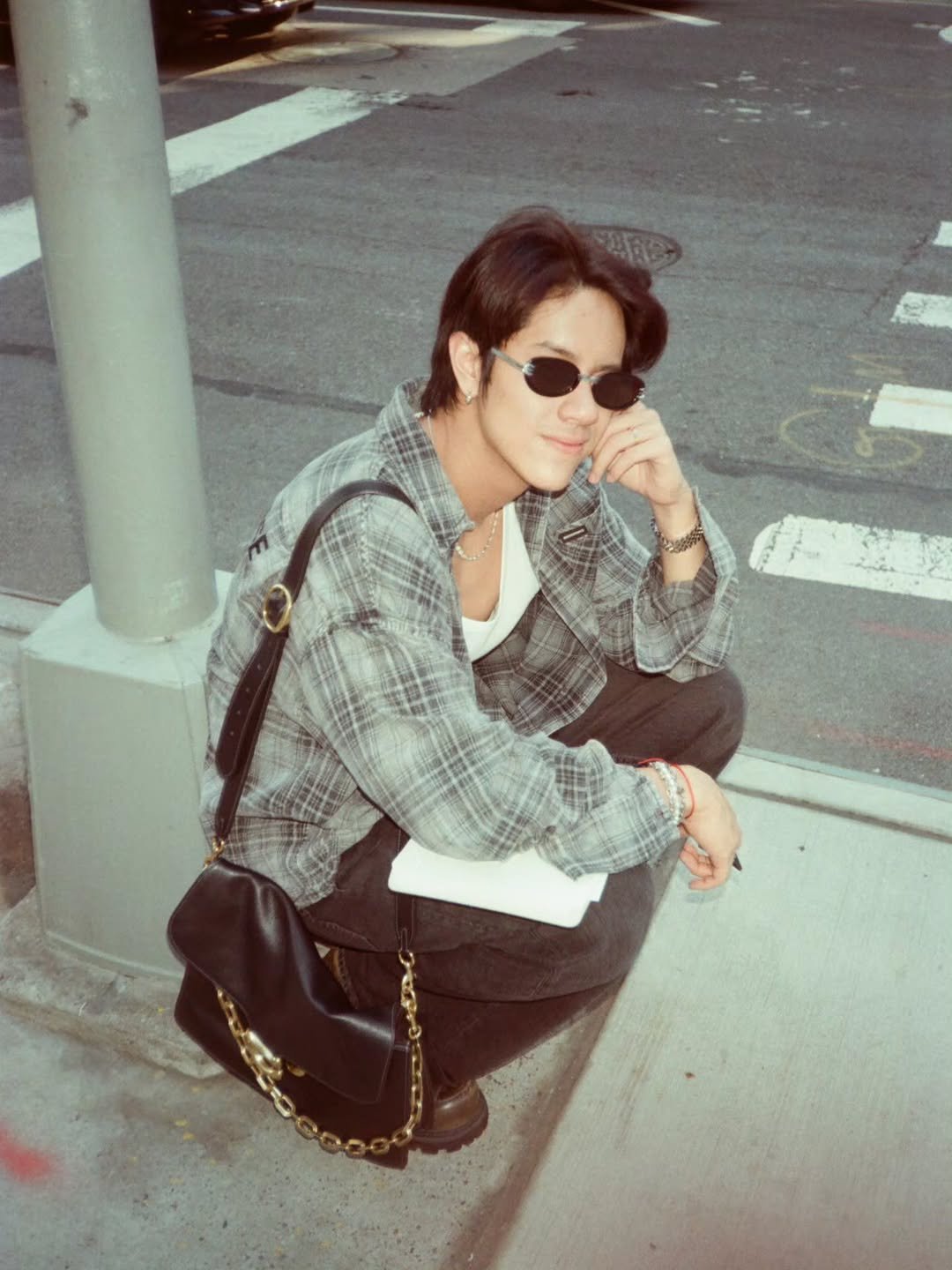 Photo by NANON on December 17, 2025. May be an image of smoking, flannel, cigarette, street and text.