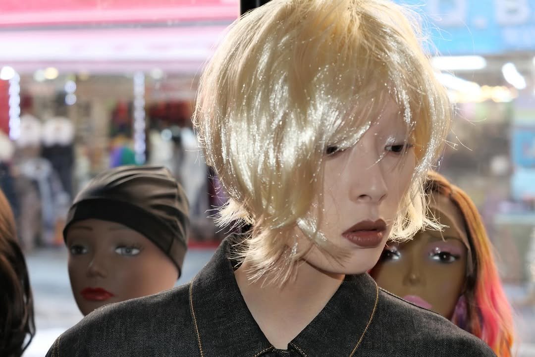 Photo shared by Choi Na Rang 최나랑 on February 13, 2026 tagging @wkorea, @minji.kimlee, @ainyoungg, @joan_jay_pak, and @ohseongseok. May be an image of one or more people, blonde hair, mannequin, bust, display case, headscarf and text.