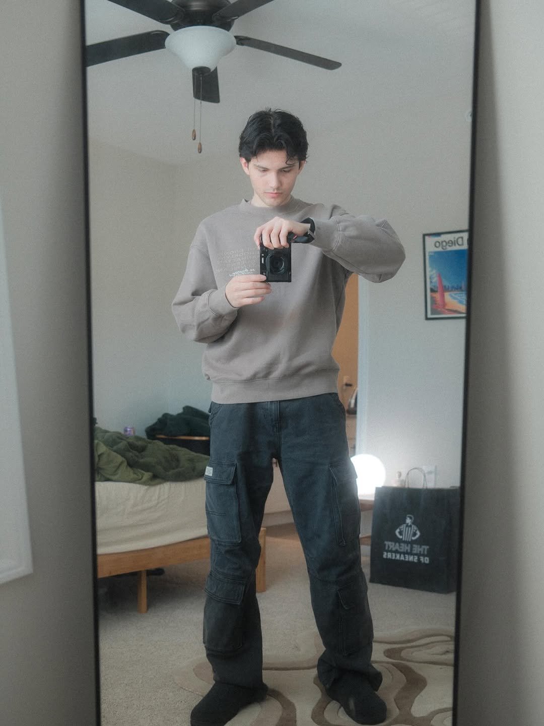 Photo by Nathan Espinoza on December 31, 2025. May be an image of standing, mirror, sweatpants, turtleneck, sweatshirt and text.