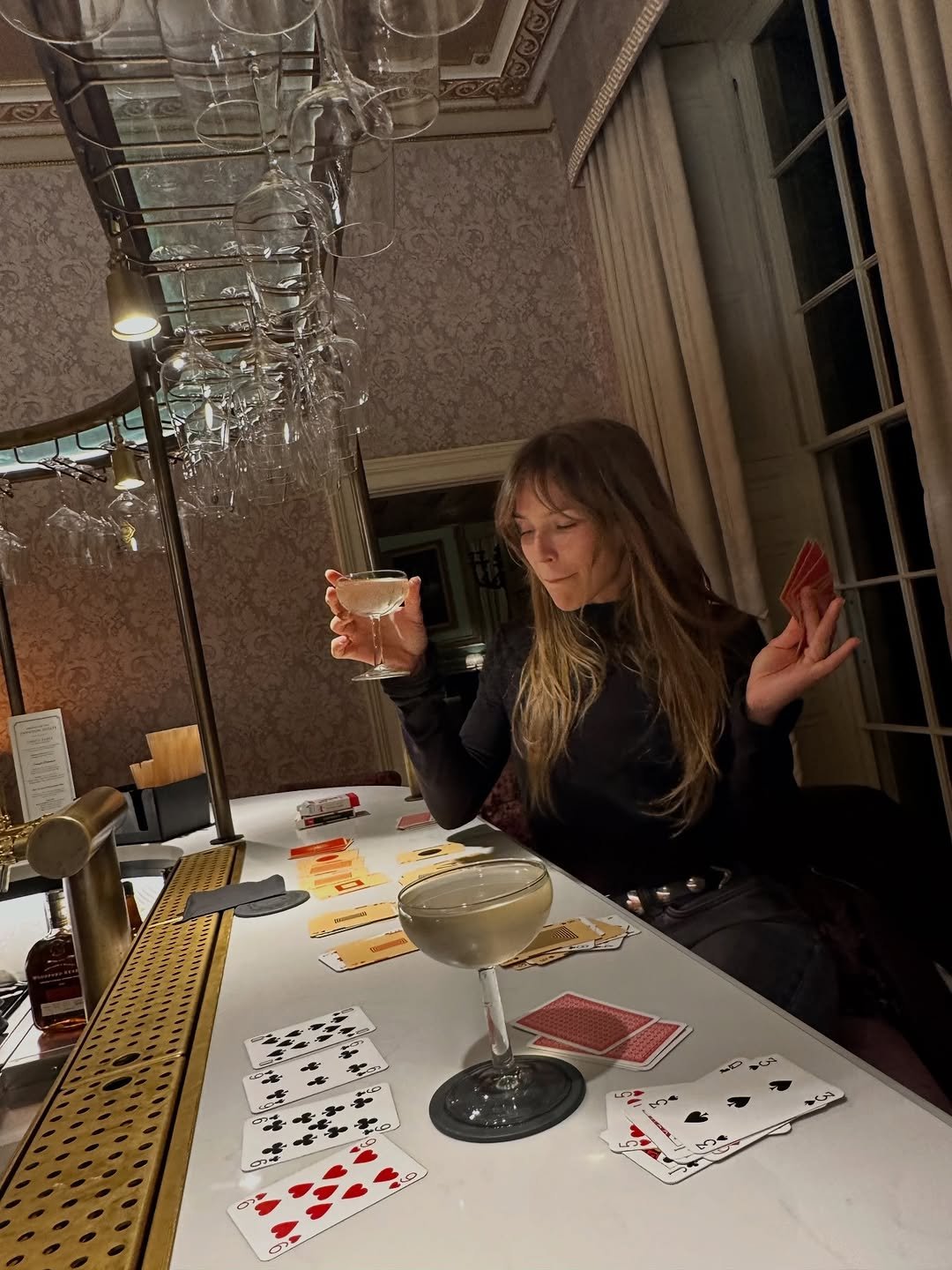 Photo by Natalia Rudin on April 16, 2026. May be an image of drink, playing cards and text.