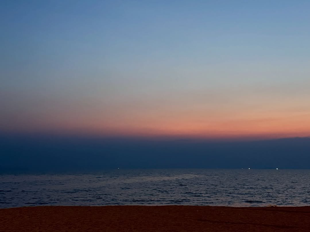 Photo by NATTY (( 나띠 )) on February 26, 2026. May be an image of beach, twilight, horizon, ocean, sky and text.
