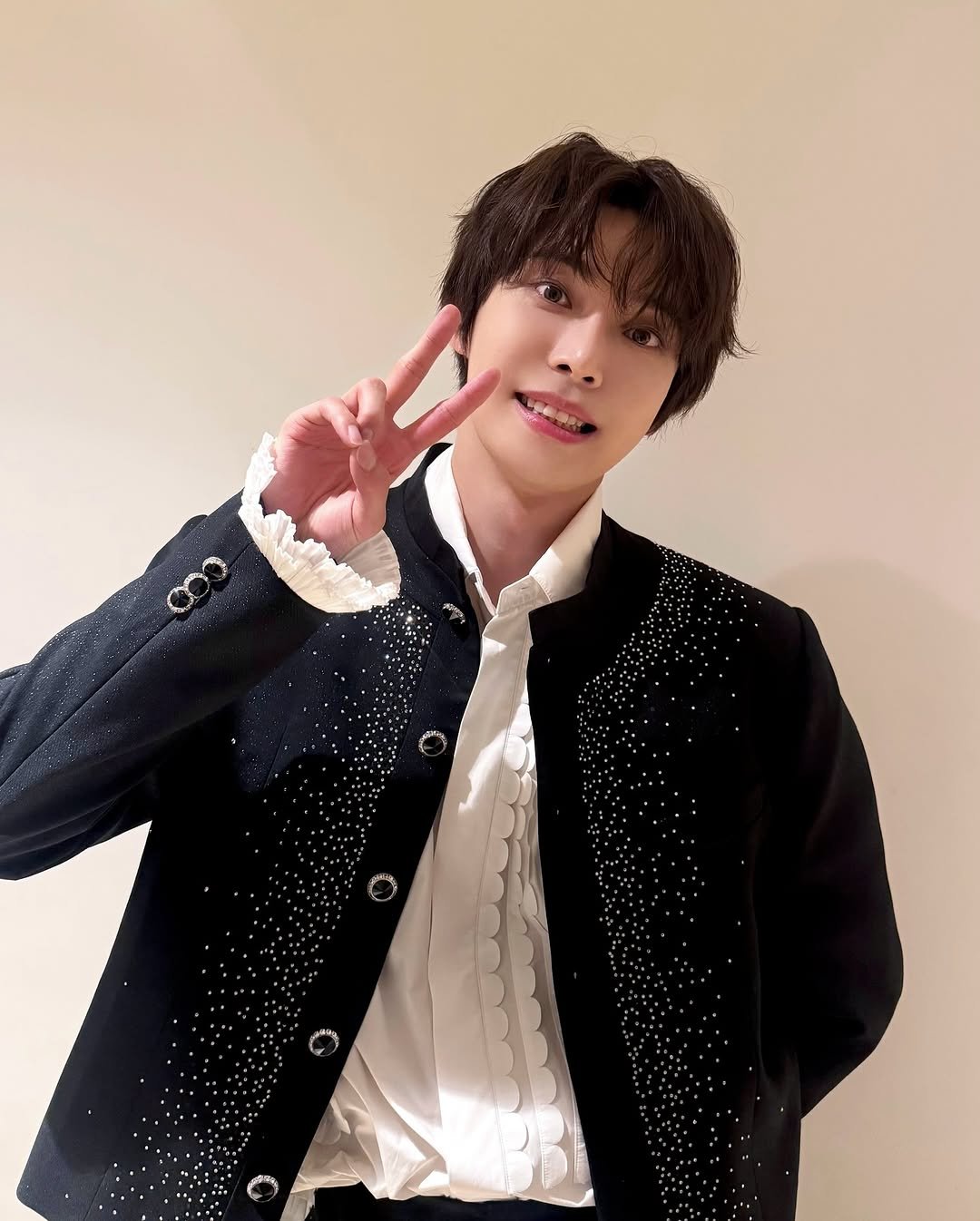 Photo shared by NCT Official Instagram on August 16, 2025 tagging @do0_nct. May be an image of 1 person, bolo tie and text.