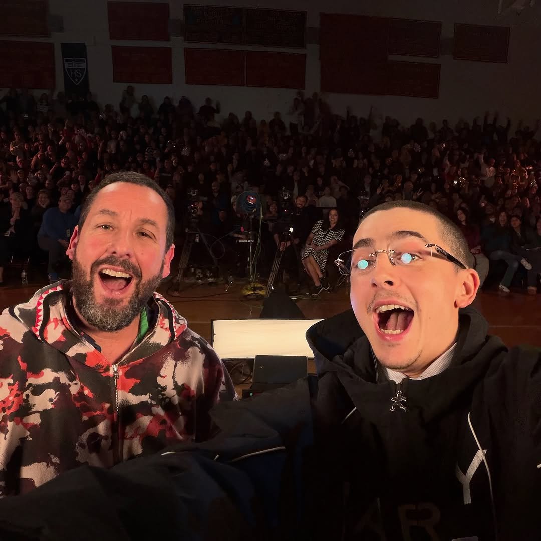 Photo shared by Netflix US on November 15, 2025 tagging @tchalamet, and @adamsandler. May be a selfie of one or more people, parka, crowd, concert and text.