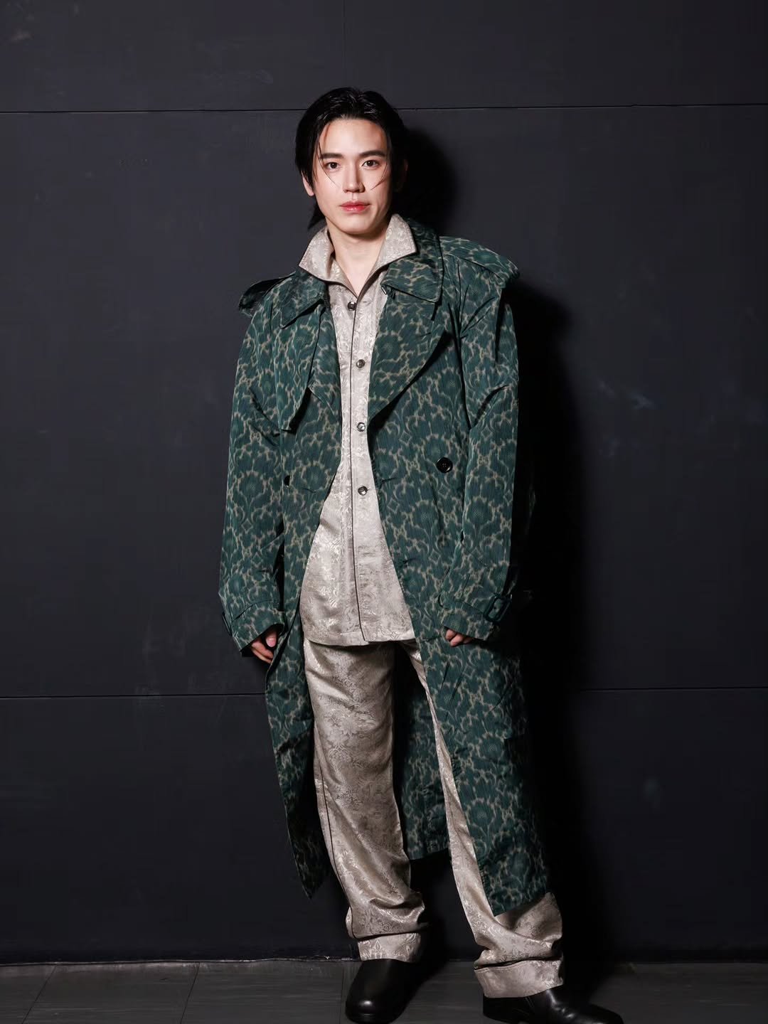 Photo shared by New Thitipoom on November 26, 2025 tagging @burberry. May be an image of duffle coat, overcoat, suit and text.