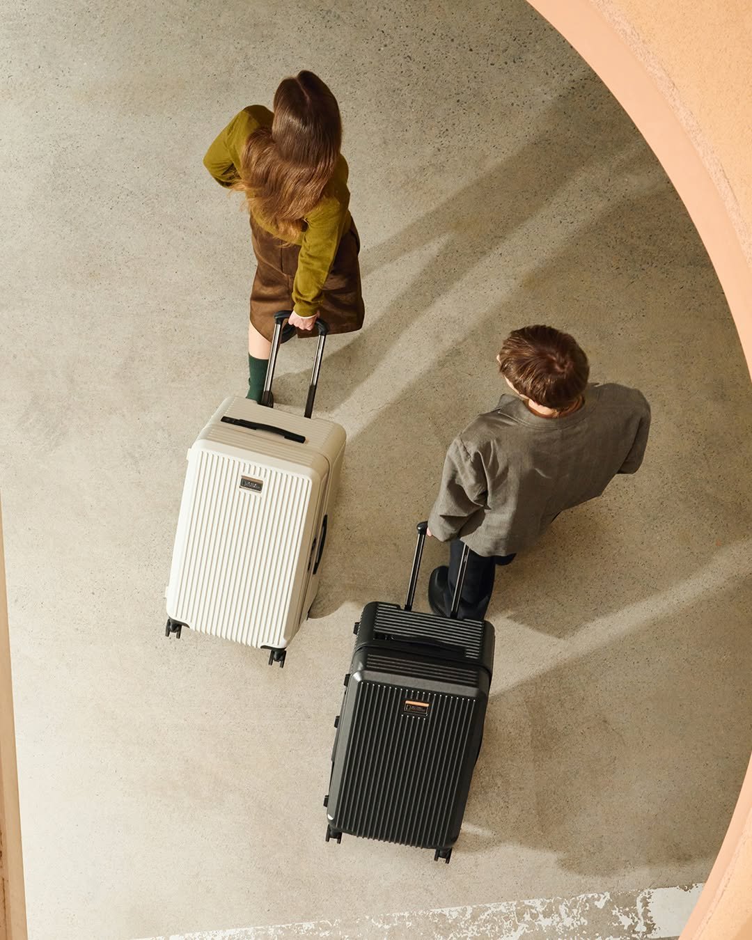 Photo by 내셔널지오그래픽 어패럴 on October 05, 2025. May be an image of 2 people, suitcase, briefcase, luggage and text.