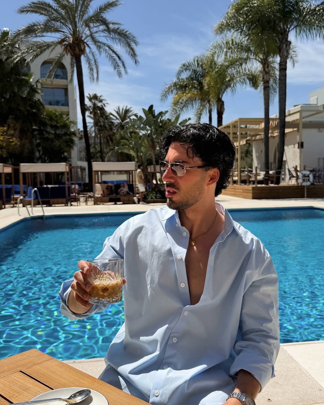 Photo shared by Nico on April 21, 2026 tagging @memarbellahotel. May be an image of eyewear, drink, pool, cabana and text.