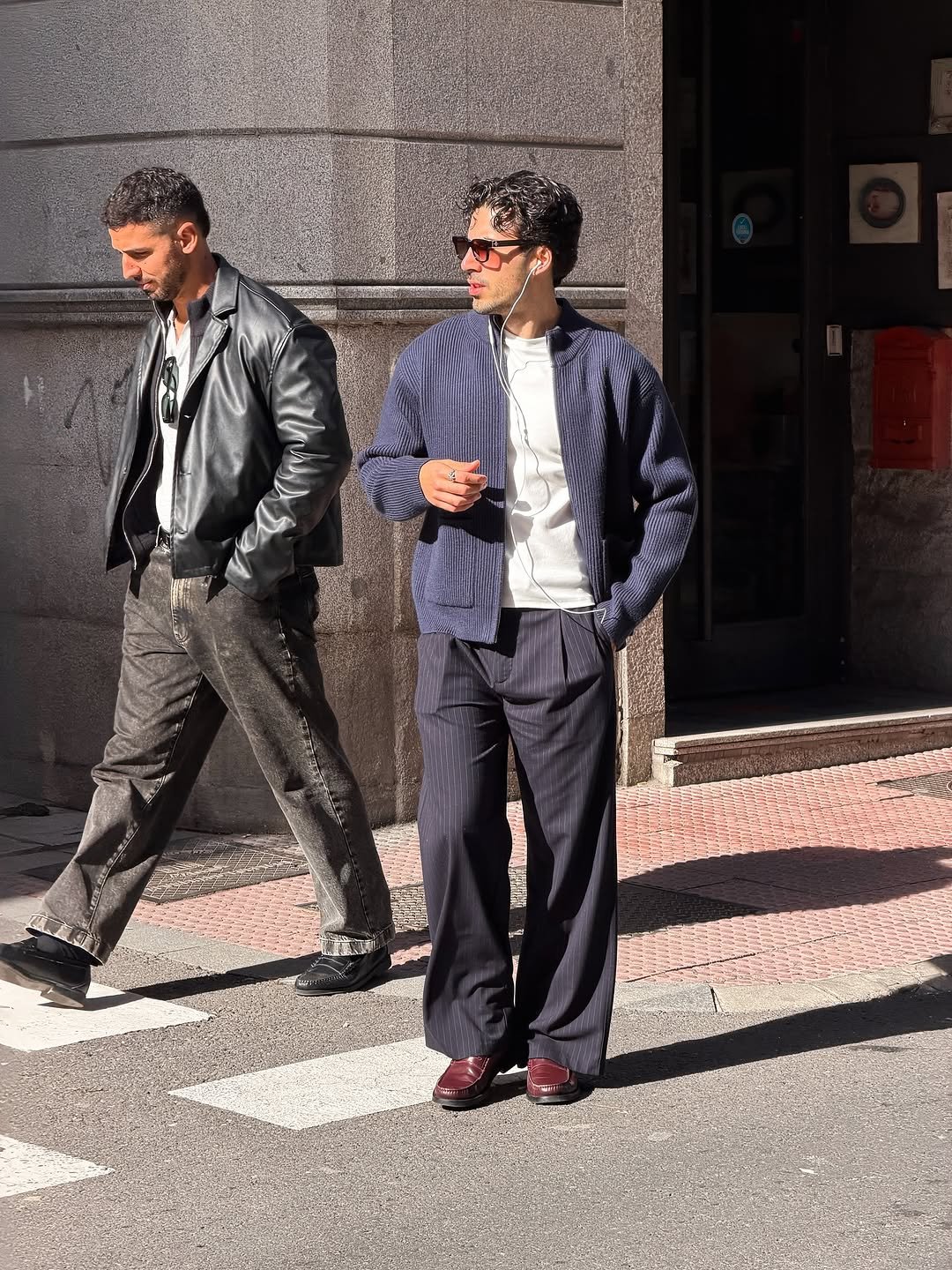 Photo by Nico on November 16, 2025. May be an image of one or more people, overcoat, suit, street and text.