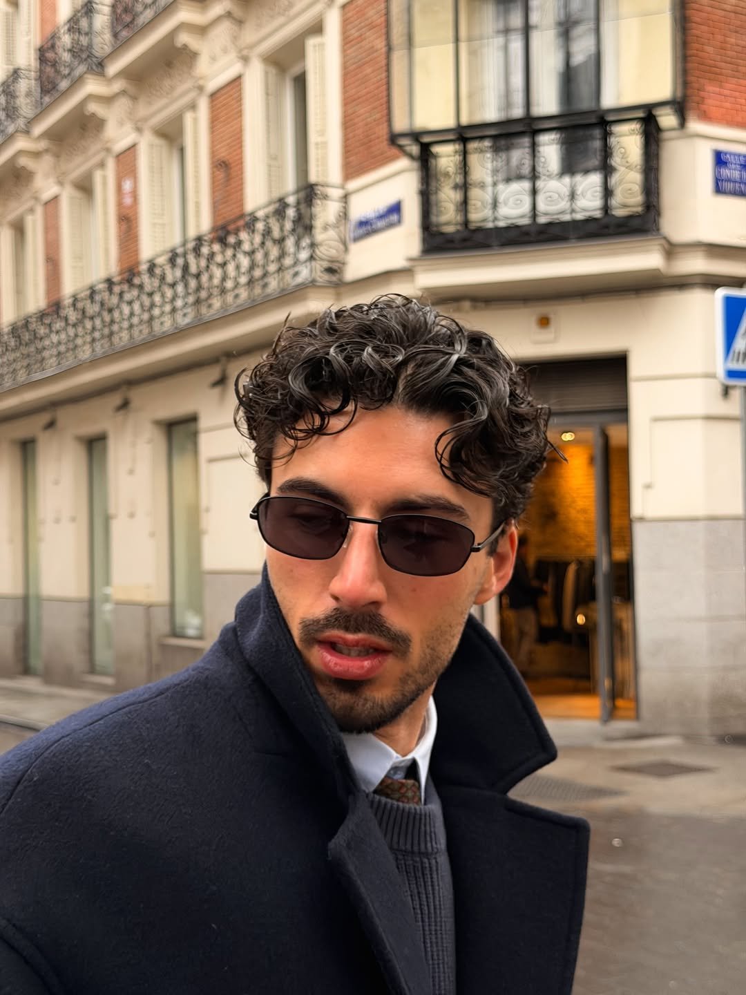 Photo by Nico on November 30, 2025. May be an image of one or more people, overcoat, duffle coat, turtleneck, sunglasses and text.