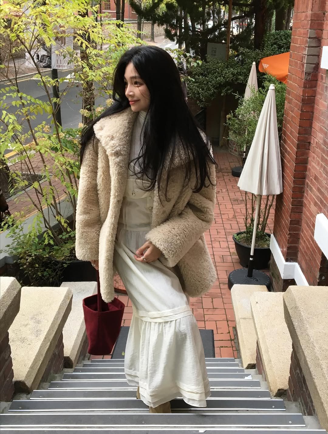 Photo shared by 여울 yeowool on November 10, 2025 tagging @octetteofficial. May be an image of overcoat, duffle coat, sable coat and text.