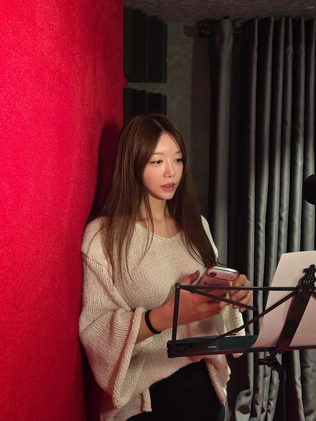 Photo by 리리 🩷 on February 02, 2026. May be an image of musical instrument, microphone and text.