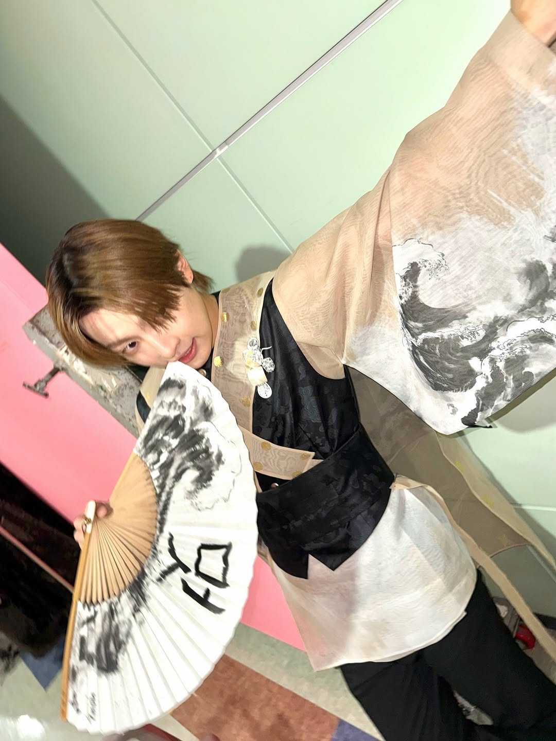 Photo by 홍중 (HONGJOONG) on December 31, 2025. May be an image of parasol, costume, robe and bath robe.