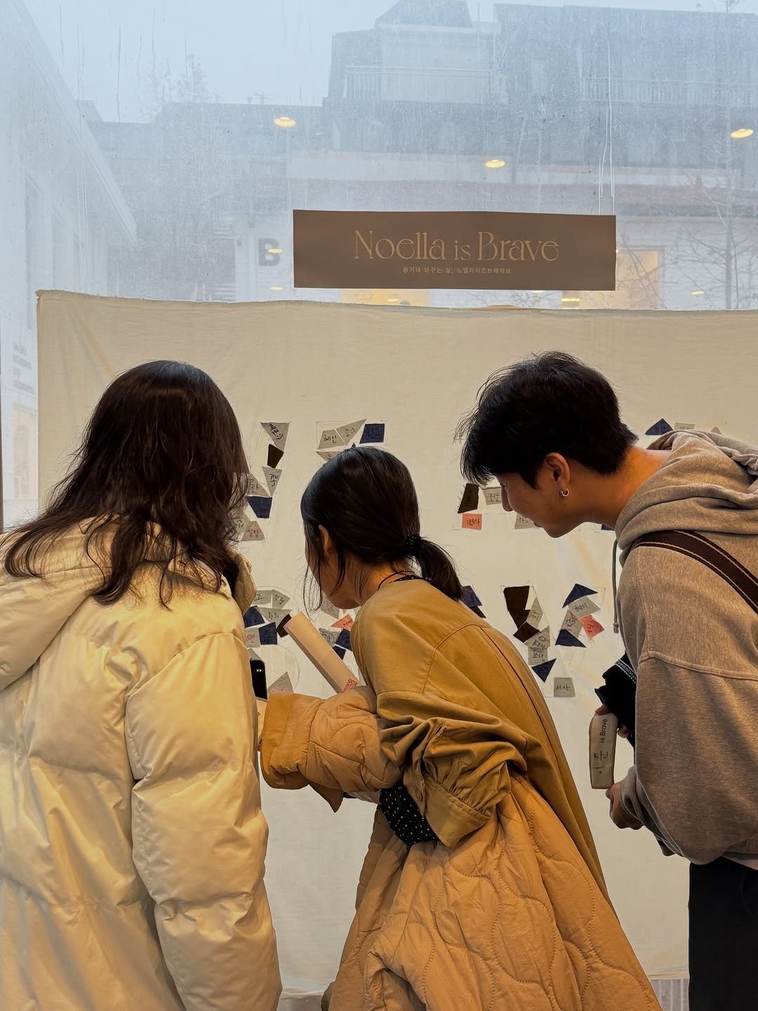 Photo shared by Noella is Brave on December 21, 2025 tagging @memyselfolive. May be an image of one or more people, people standing, overcoat, umbrella and text.