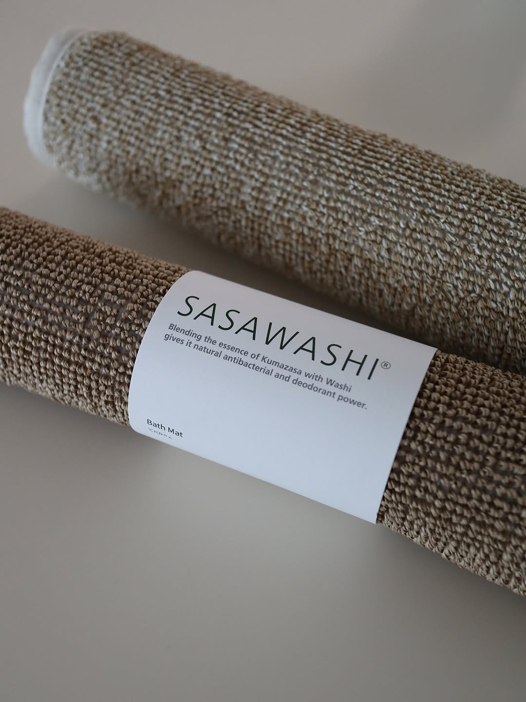Photo by Noella is Brave on January 11, 2026. May be an image of mat, placemat, bathmat, carpet and text that says 'gives Blending the natural essence antibacterial of Kumazasa SASAWASHI® SASAWASHI sit and deodorant with Washi power. Bath Smh at'.
