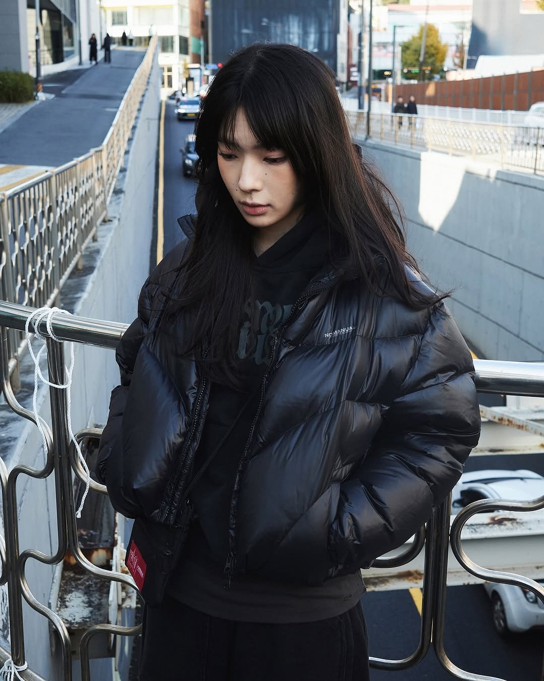 Photo by NOMANUAL® on November 17, 2025. May be an image of duffle coat, overcoat, sable coat, goosedown coat, parka, flight jacket and text.