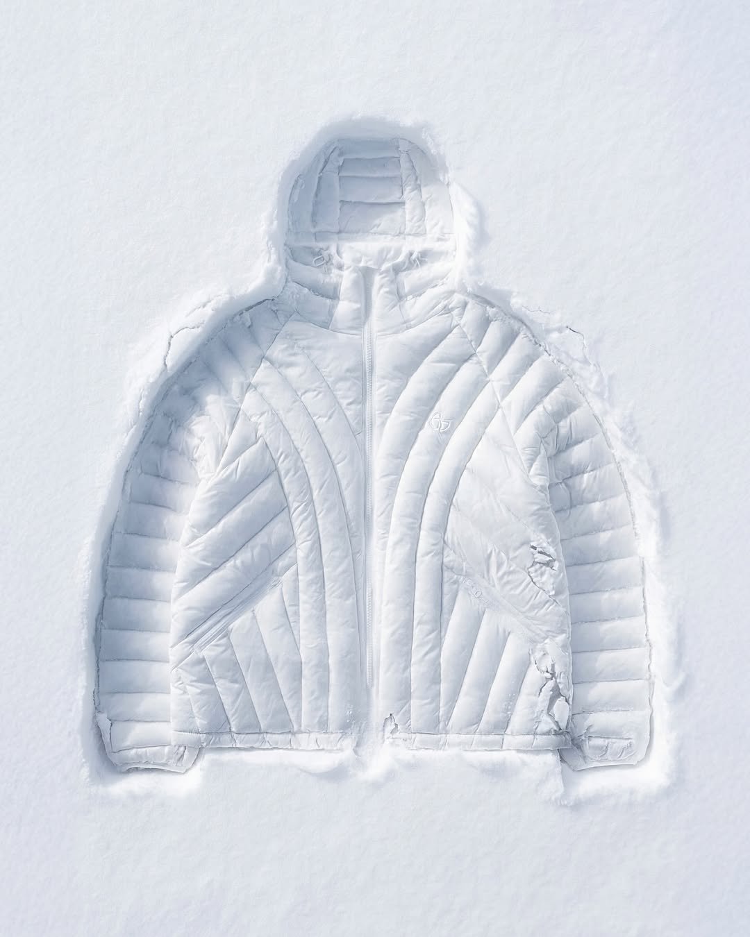 Photo by NOMANUAL® on January 05, 2026. May be an image of goosedown coat, jacket, snowsuit, parka, ski, vest, arctic, ski slope, snow and text.