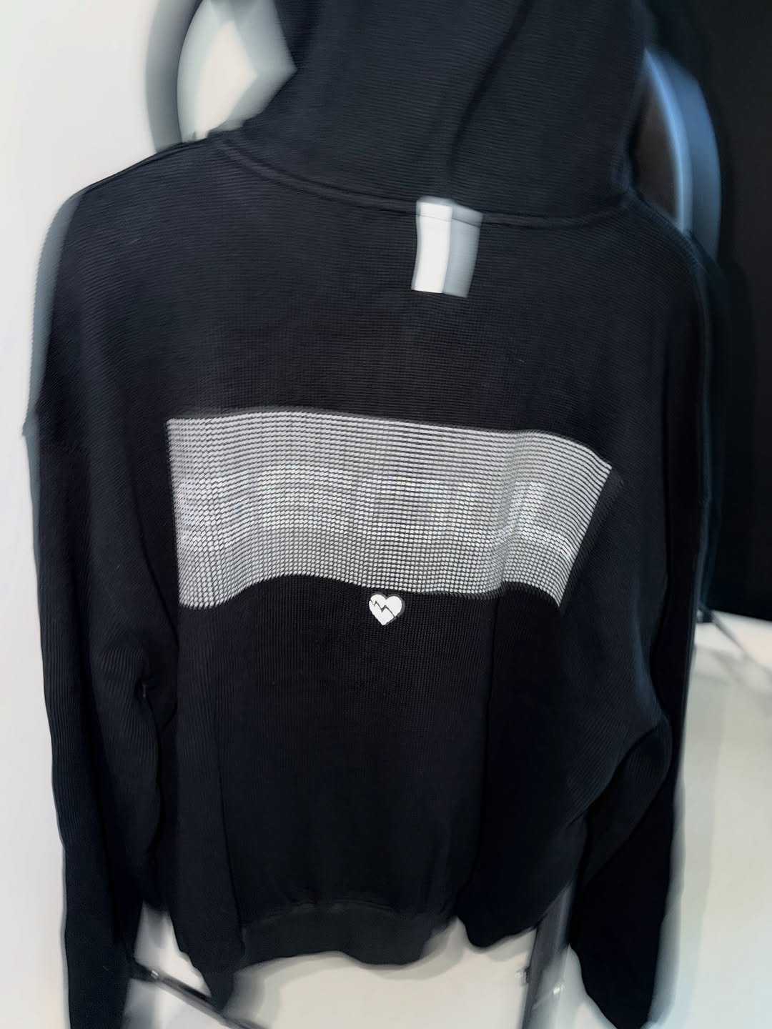 Photo shared by NOMANUAL® on November 18, 2025 tagging @thisloop. May be an image of top, turtleneck, sweatshirt, sweater, fishnet stockings and text.