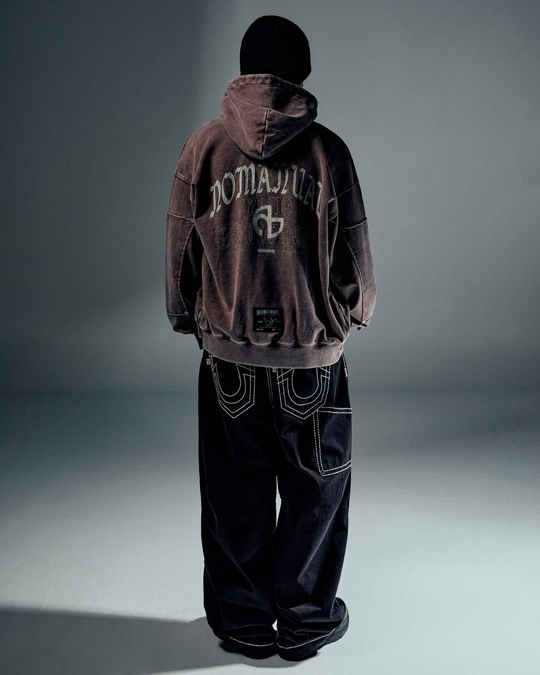 Photo shared by NOMANUAL® on September 16, 2025 tagging @nomanual.designs, and @truereligion.kor. May be an image of duffle coat, parka, face mask, bandanna and text.