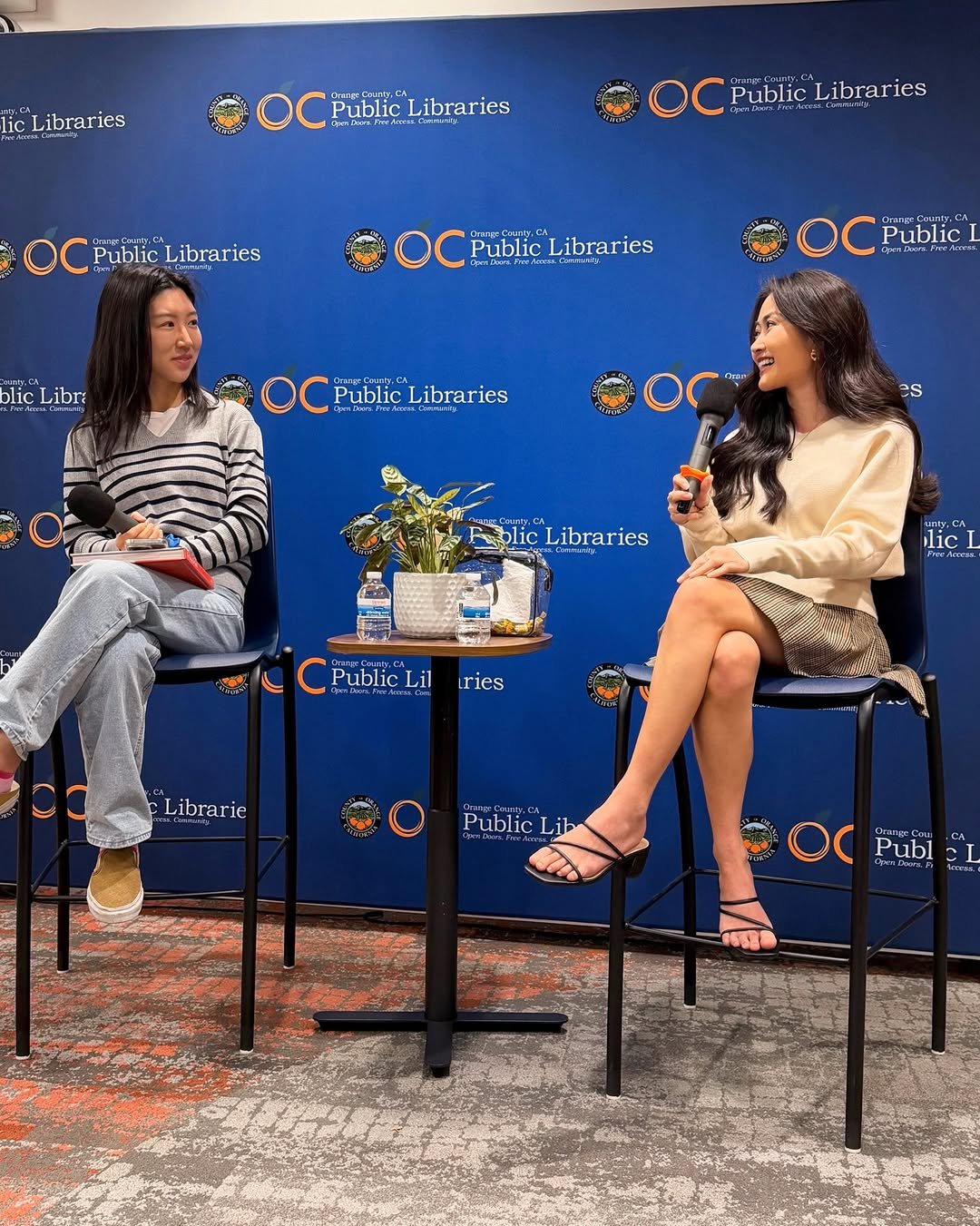 Photo shared by Kylie Sakaida on January 29, 2026 tagging @ahnestkitchen. May be an image of one or more people, carpet, microphone and text that says 'lic Libraries PublicLibraries AЛeamи Public bblic Libraries Public Librar PublicLibraries ries PublicLibraries Public Libraries PublicLibraries Public Libraries olic Libri CrangCourey Public warr.mA OC ChrppPar.es Public PublicLibraries Libraries es Libraries ries lic] CnepCaaty.c Public Lil iries Librarie Public PublicLib Lib Publ I'.