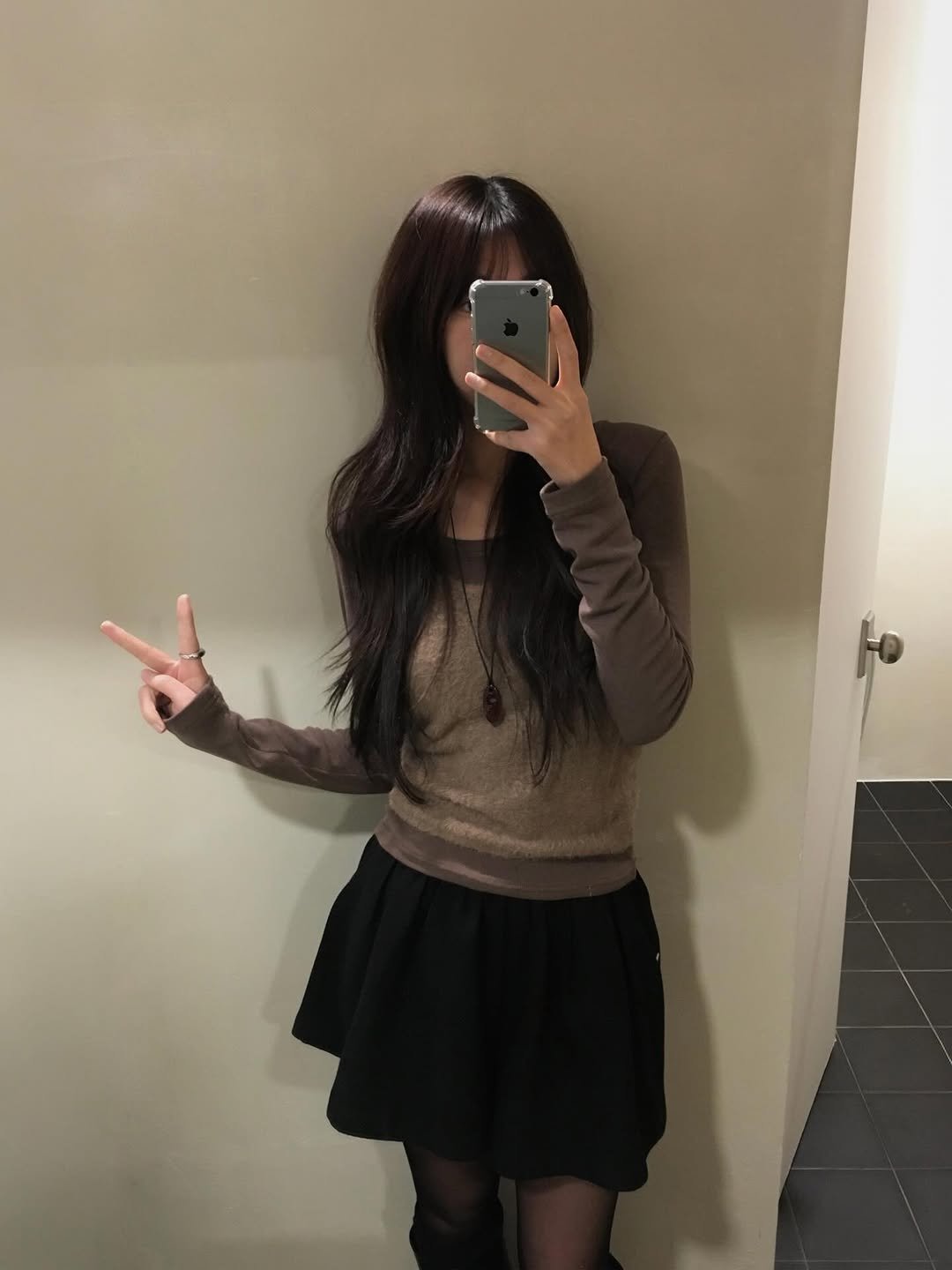 Photo by 오베럴 | obetter on December 21, 2025. May be a selfie of miniskirt, sweater, tights and text.