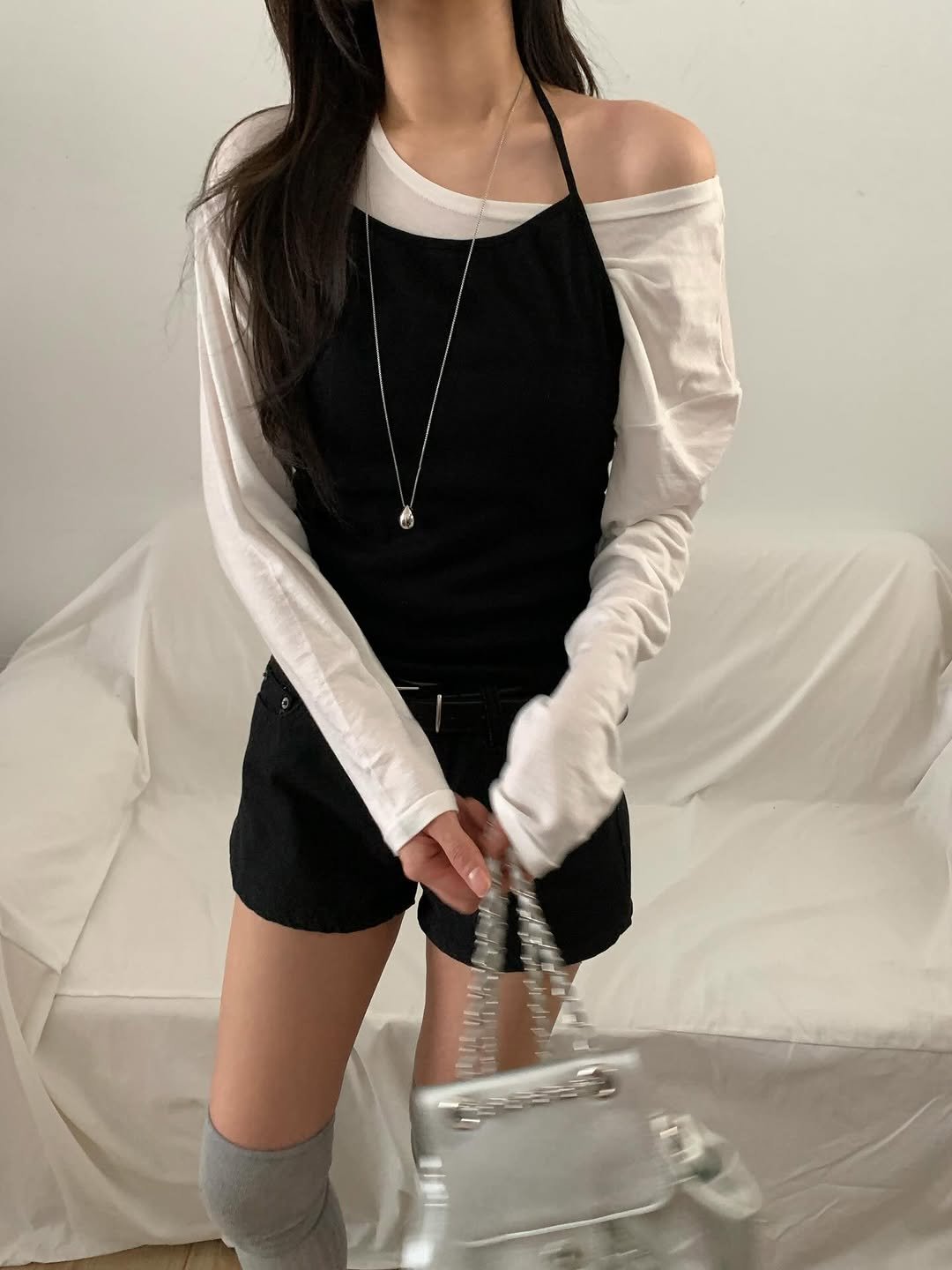 Photo by 오베럴 | obetter on February 22, 2026. May be an image of turtleneck, purse, drawstring, top, dress and text.