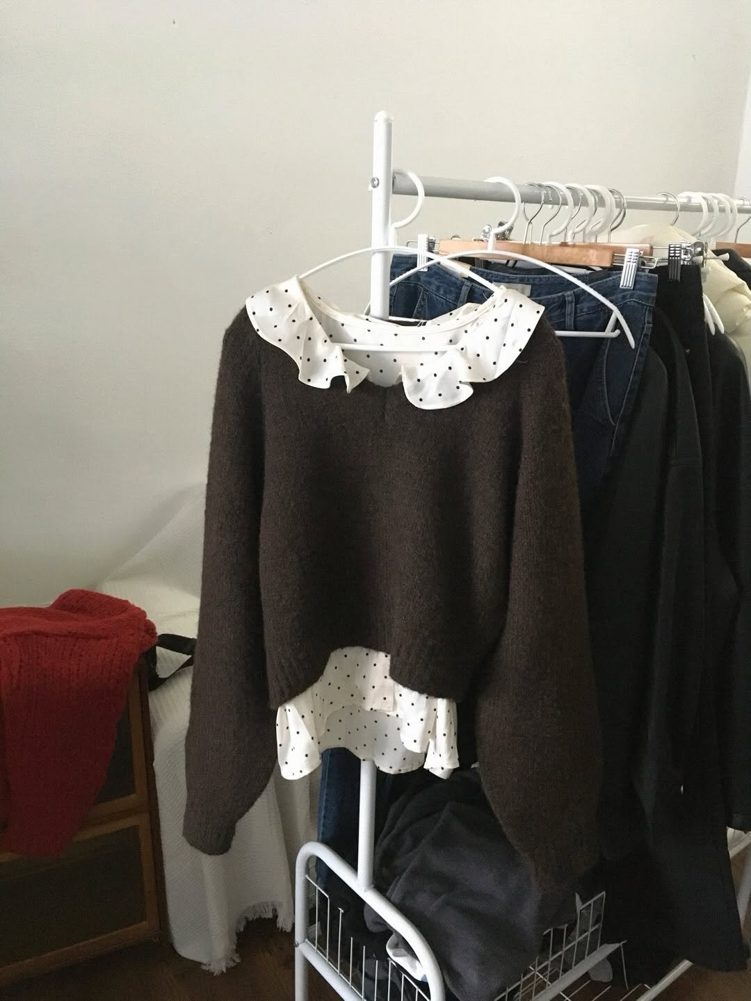 Photo by 오베럴 | obetter on January 04, 2026. May be an image of cardigan, sweater, rack, clothes hanger and text.