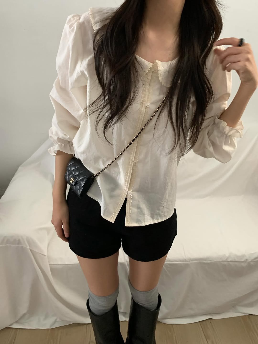 Photo by 오베럴 | obetter on February 23, 2026. May be an image of miniskirt, boots, shorts, top and text.