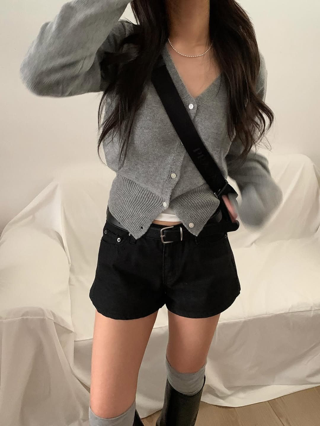 Photo by 오베럴 | obetter on February 22, 2026. May be an image of belt, boots, turtleneck, shorts, sweater, miniskirt, top and text.