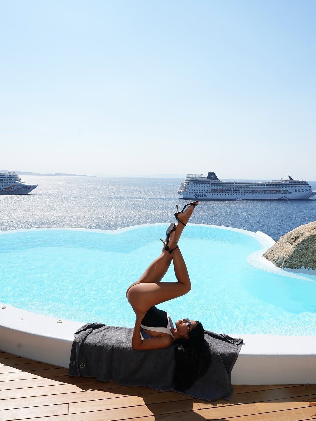 Photo by Ingrid Ohara in Cavo Tagoo Mykonos with @oharaingrid, @cavotagoomykonos, @soulaliakou, and @nicktheonly. May be an image of 1 person, practicing yoga and pool.
