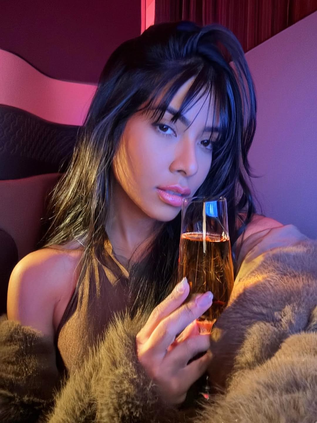 Photo by Ingrid Ohara on November 19, 2025. May be an image of one or more people, makeup, champagne, fur and text.
