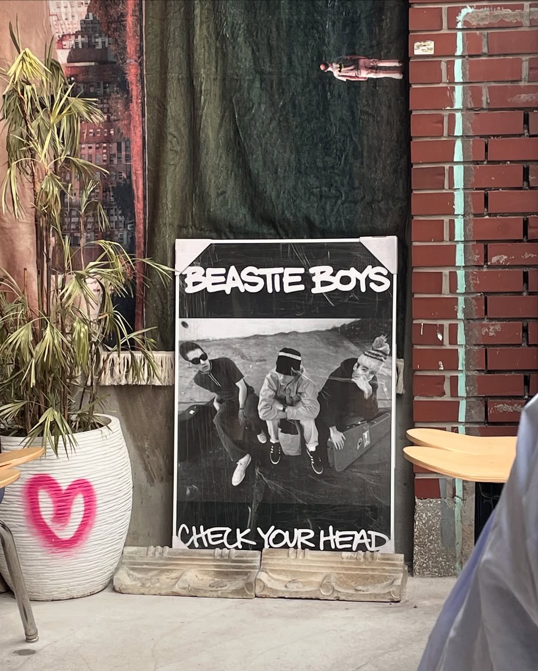 Photo by Hyewon on February 13, 2025. May be an image of 2 people, heart, newspaper, magazine, poster, brick wall and text that says '-S BEASTIE BOYS CHECKYOURHEAD YOUR CHELK'.