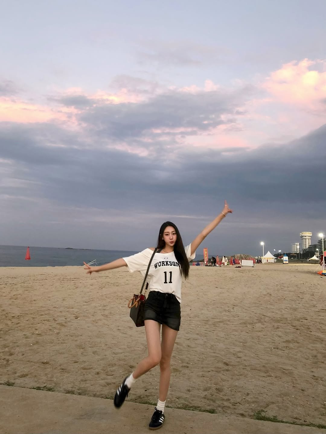 Photo by 장진원 JINWON on August 12, 2025. May be an image of 1 person, shorts, beach and text.