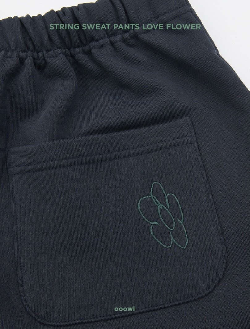 Photo by ooowl on February 24, 2026. May be an image of stitching, drawstring and text that says 'STRING SWEAT PANTS STRINGSWEATPANTSLOVEFLOWER LOVE FLOWER ooowl'.