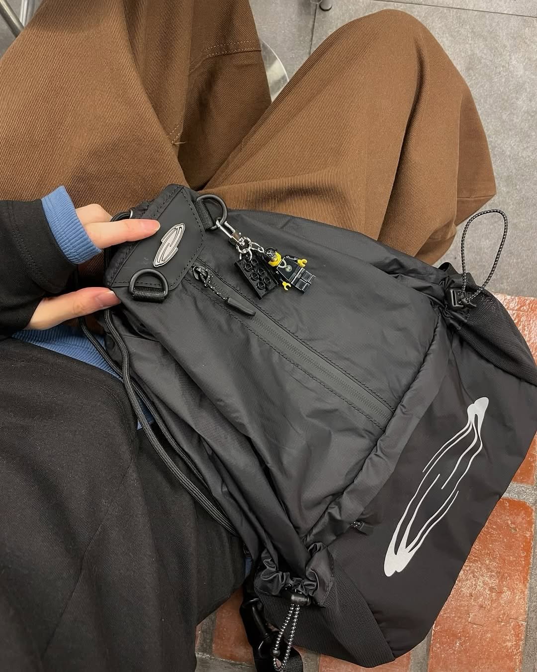 Photo by Opening Project on September 09, 2025. May be an image of duffle coat, tool bag, sling, drawstring, parka and text.