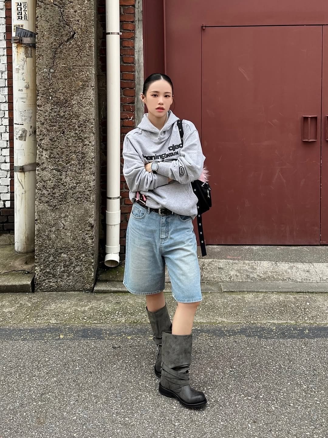 Photo by Opening Project on October 22, 2025. May be an image of raincoat, boots, turtleneck, sweatshirt and text.