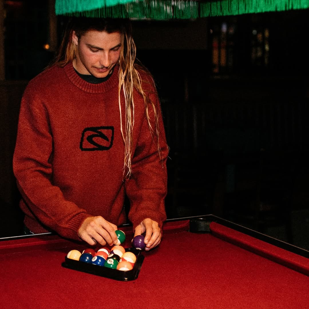 Photo shared by Oscar Langburne on March 17, 2026 tagging @ripcurl. May be an image of billiards, sweater and text.