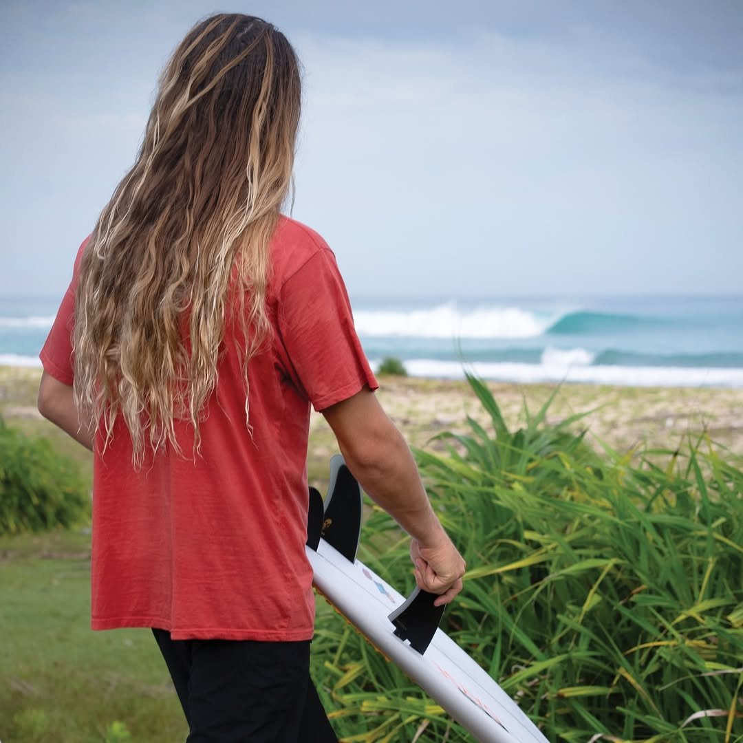 Photo shared by Oscar Langburne on March 09, 2026 tagging @fcs_surf, @ryzphoto, @christensonsurfboards, @onboardstorebali, and @agamui. May be an image of surfboard, wetsuit, water and text.