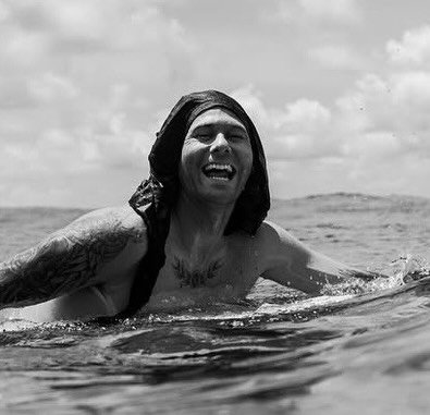 Photo by Oscar Langburne on December 05, 2025. May be a black-and-white image of surfboard, wetsuit, ocean and text.