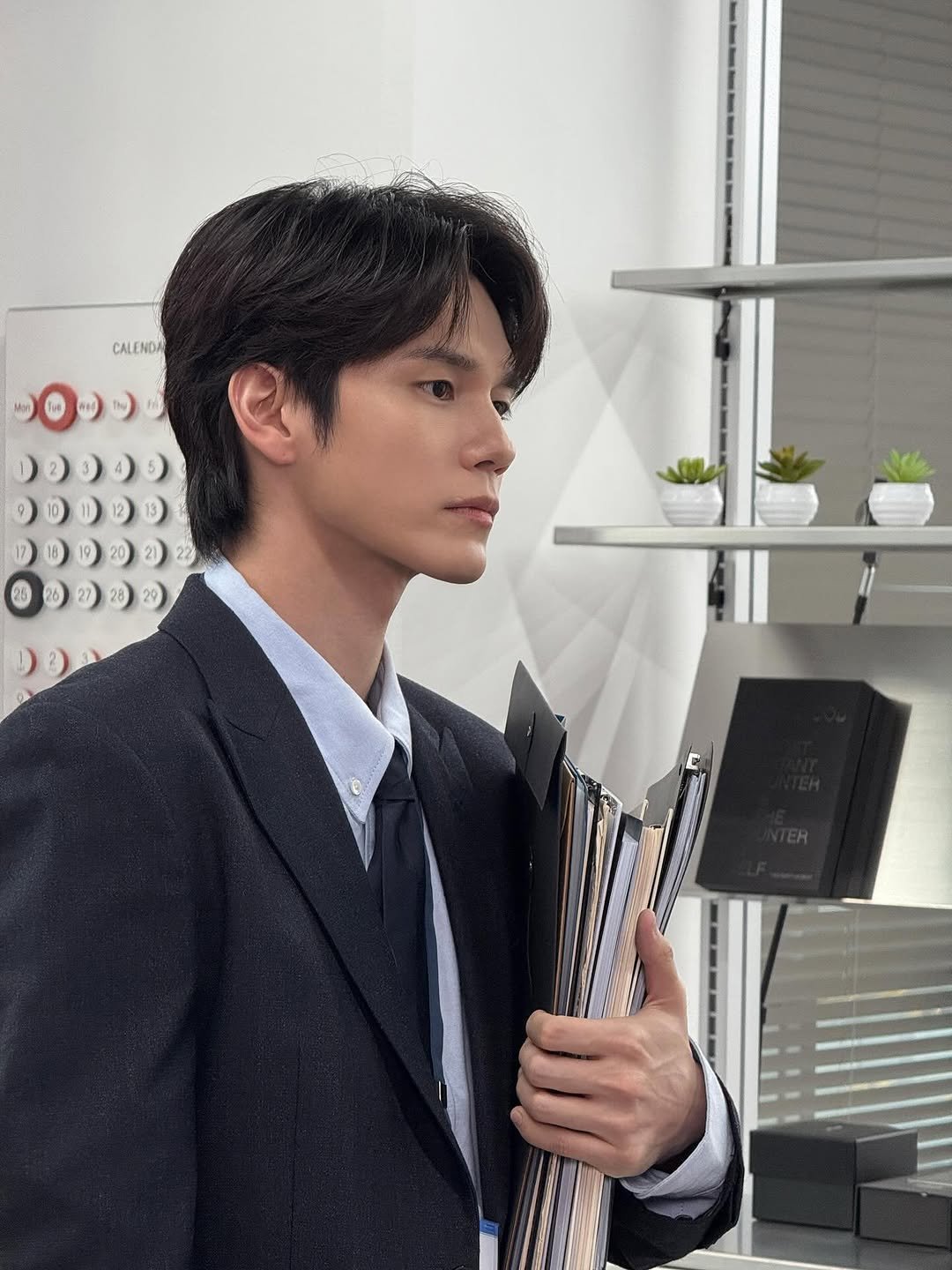 Photo shared by 옹성우 ongseongwu on November 14, 2025 tagging @fantagio_official. May be an image of one or more people, suit, blazer and text.