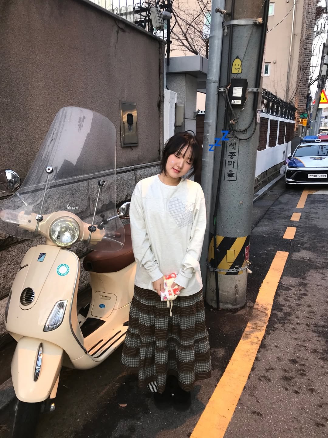 Photo shared by 쑤 on December 14, 2025 tagging @e.zkim. May be an image of parka, scooter, street and text.