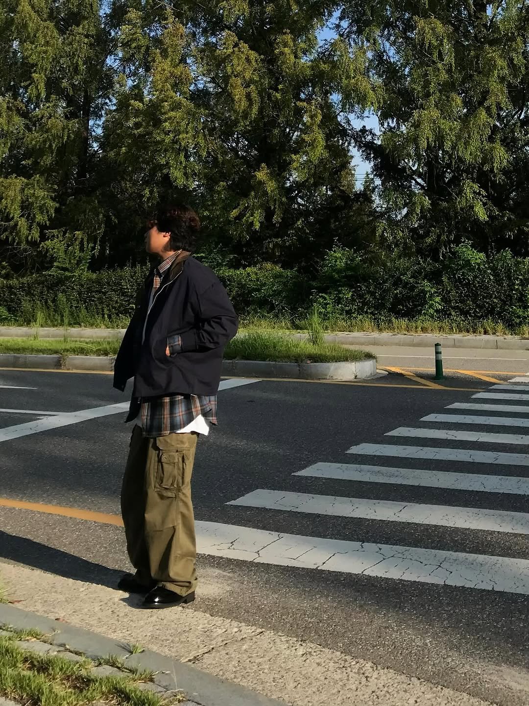Photo shared by 오윤택/오태기 on September 26, 2025 tagging @ohtaeki_official. May be an image of 1 person, standing, street, road, curb and text.