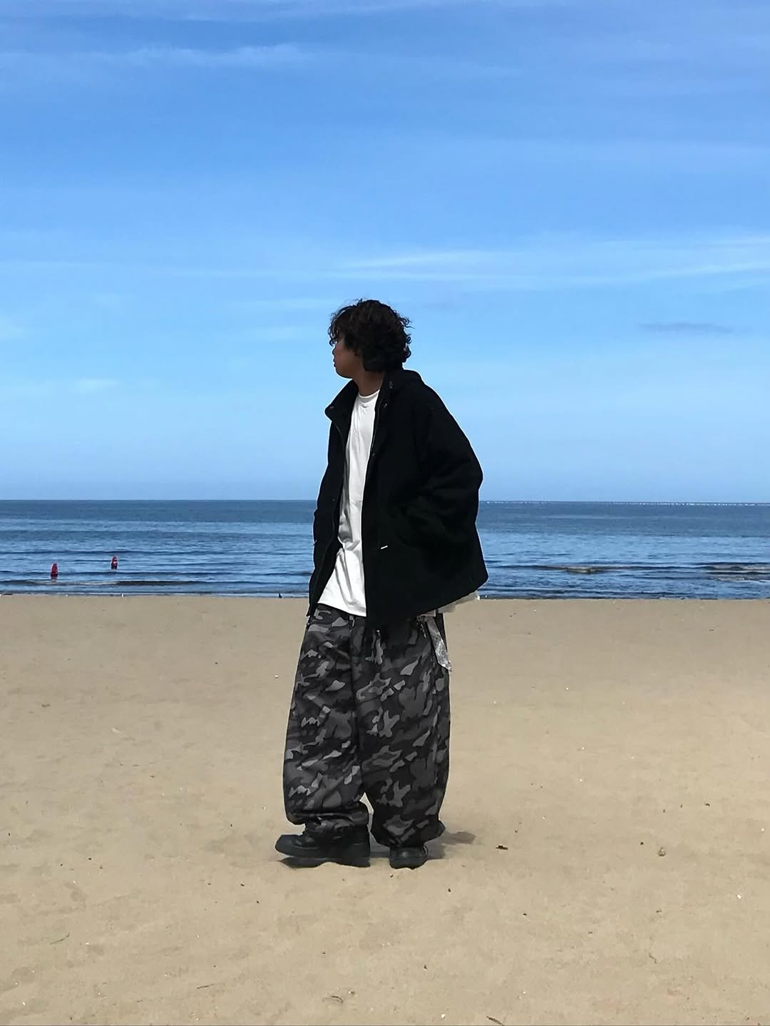Photo shared by 오윤택/오태기 on September 03, 2025 tagging @ohtaeki_official. May be an image of 2 people, overcoat, sarong, ocean, coast and text.